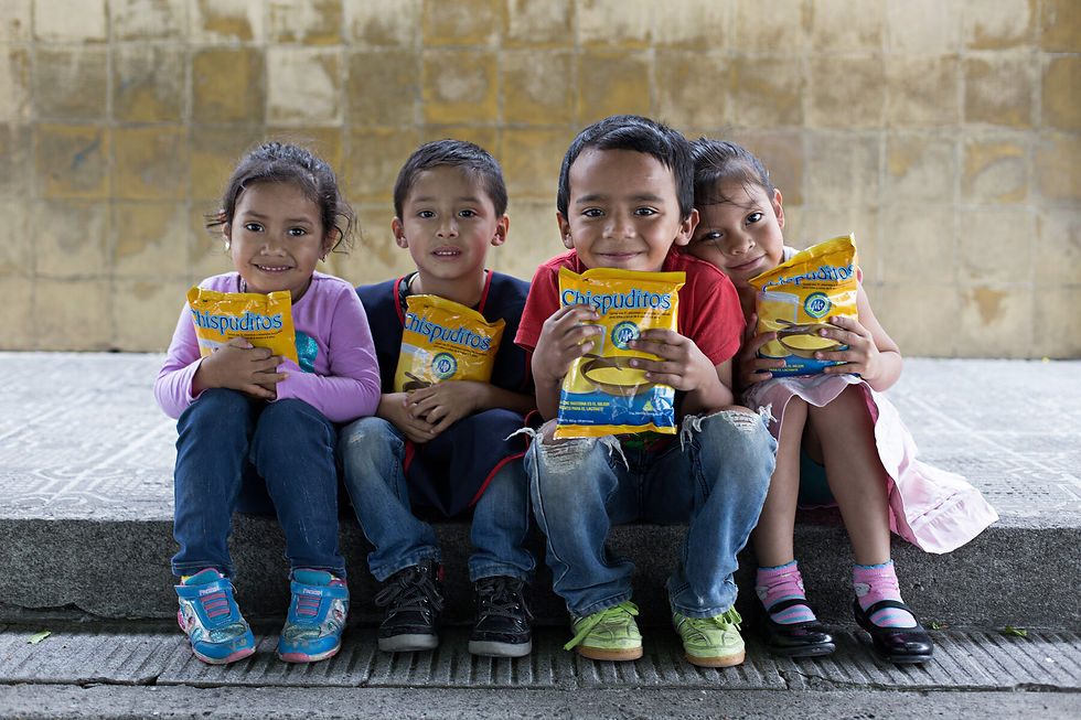 Children holding nutrition supplement bags